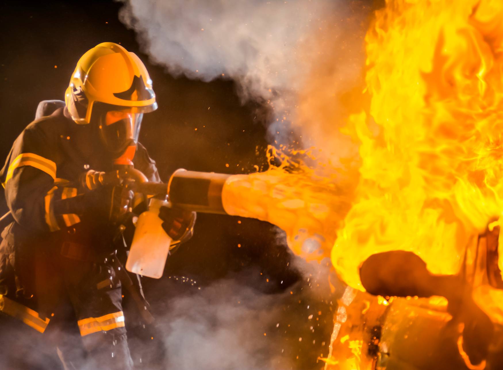 firefighter trying to extinguish fire